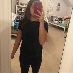 black t-shirt with speckles of white in it